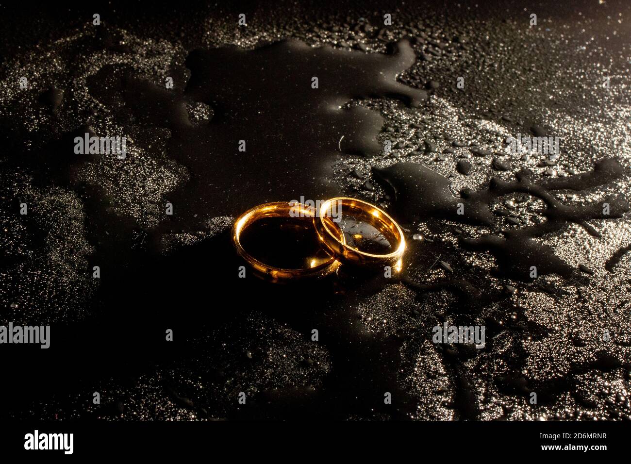 Two golden wedding rings on black background Stock Photo Alamy