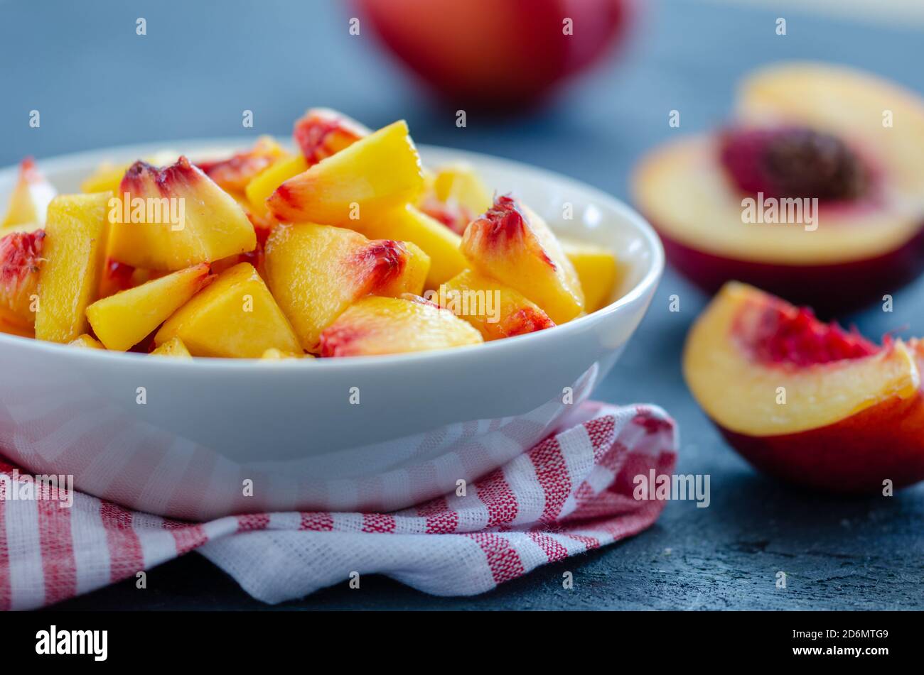 Chopped peaches  on a  table,  closeup. It is ready to make compote or jam Stock Photo
