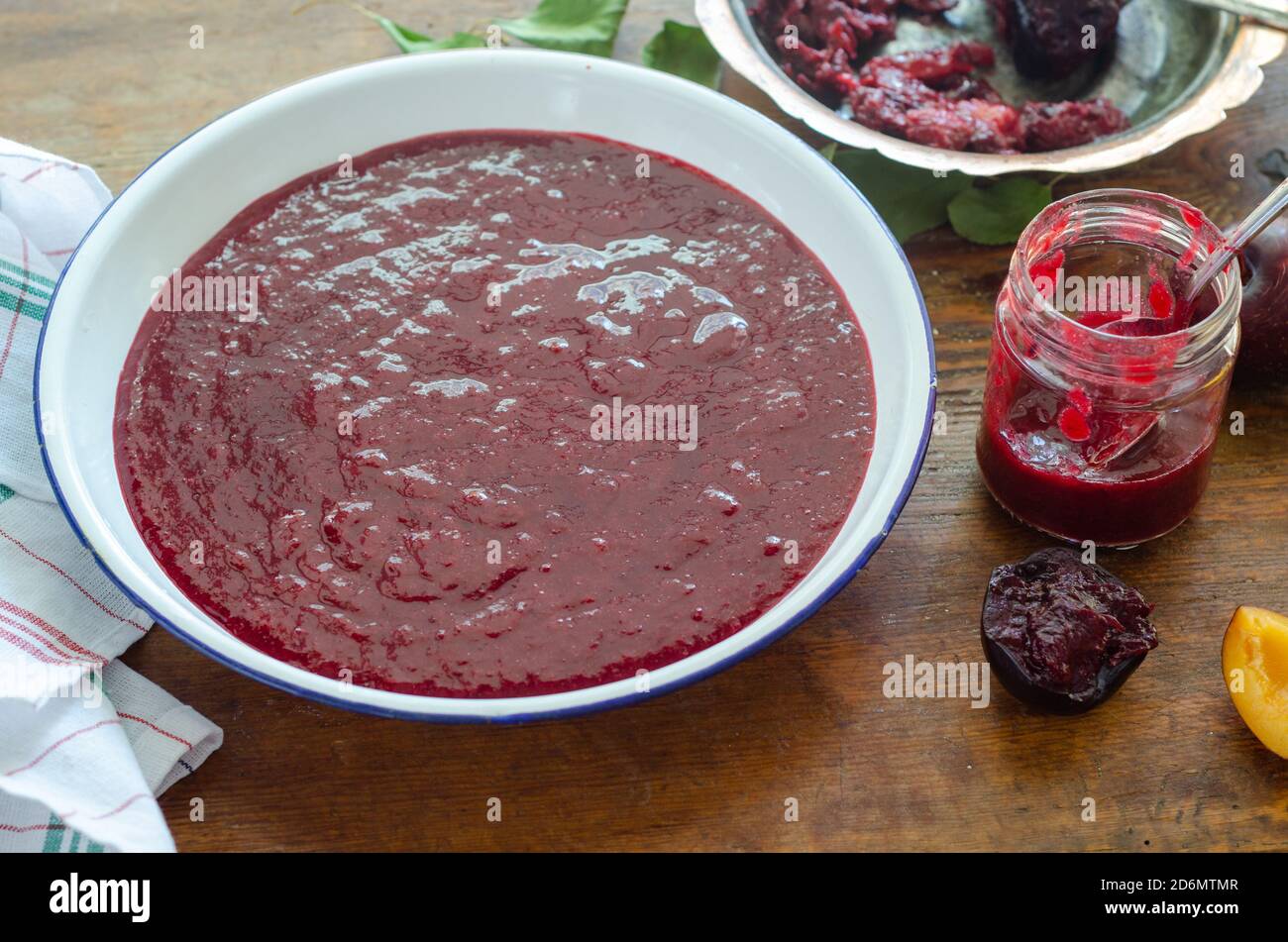 Red plum marmalade on the table. Stock Photo