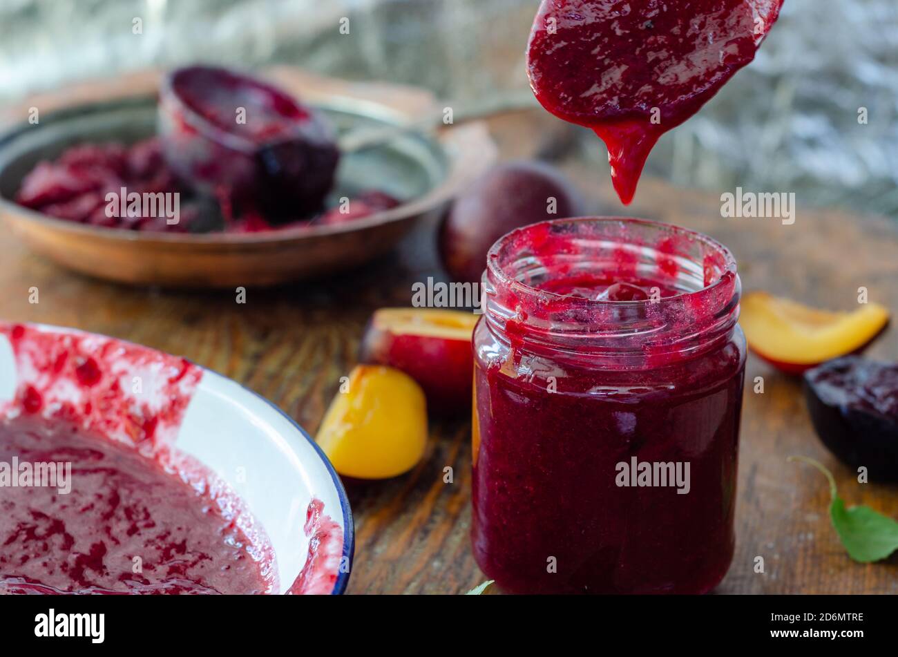 Red plum marmalade on the table. Stock Photo