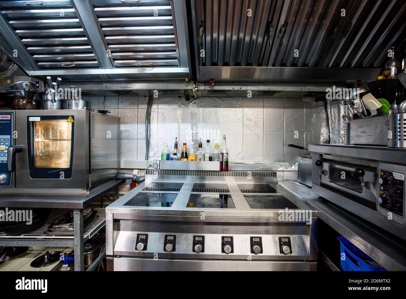 Part of interior of modern restaurant kitchen including electric stove and oven Stock Photo