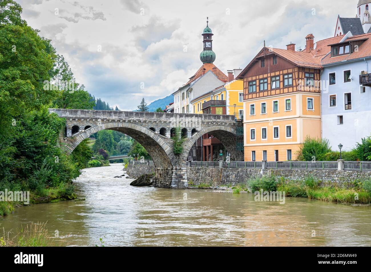 Arch bridge over river Mur in historic town of Murau in central eastern Alps, Austria Stock Photo