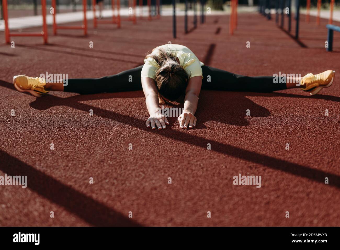 Female gymnast sitting in twine position on fresh air Stock Photo Alamy