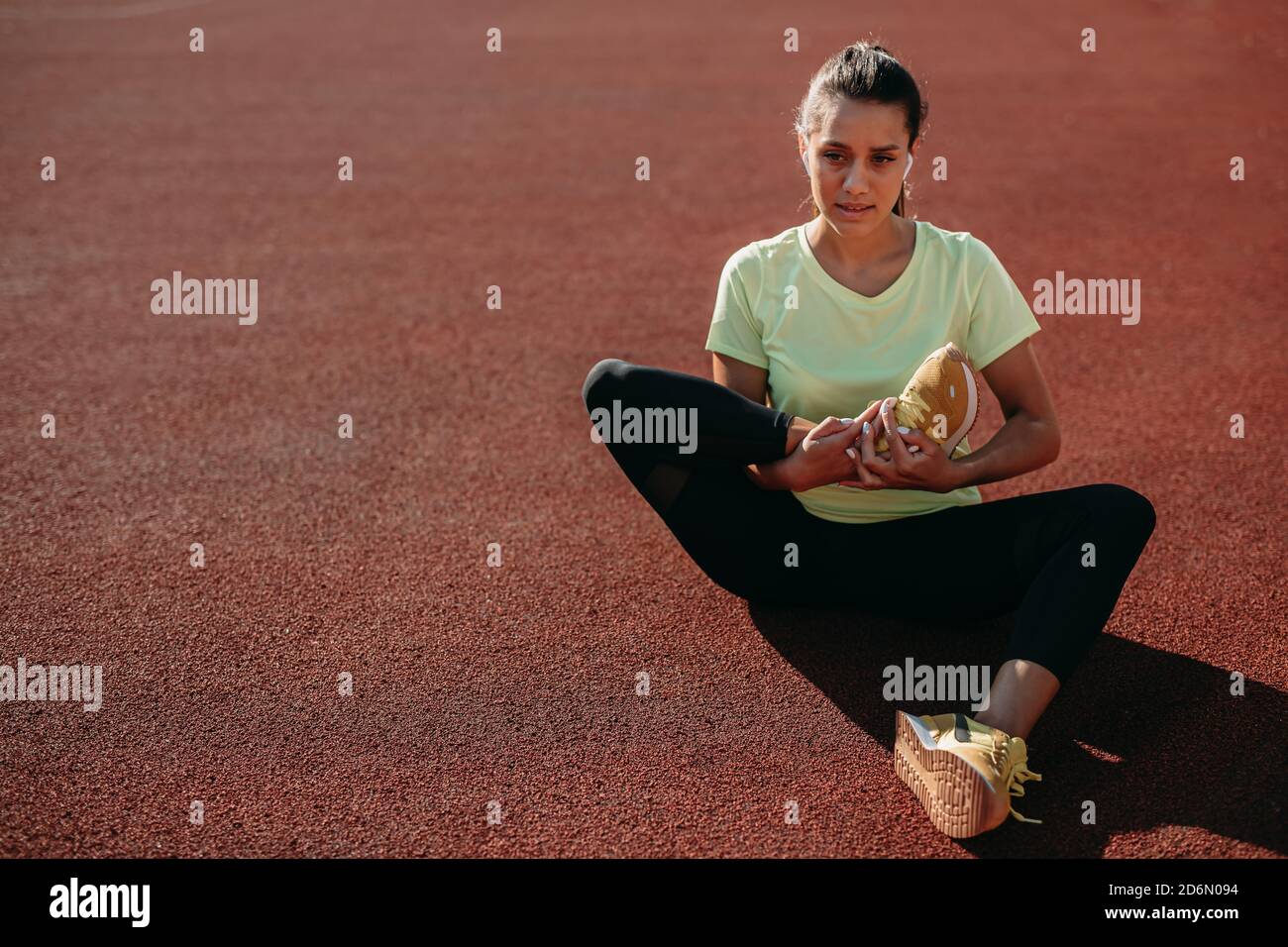 Pretty young woman doing stretching exercises Stock Photo