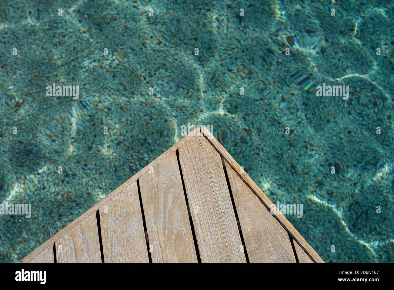 Top view of wood platform or terrace jetty beside the blue crystal clear water background Stock