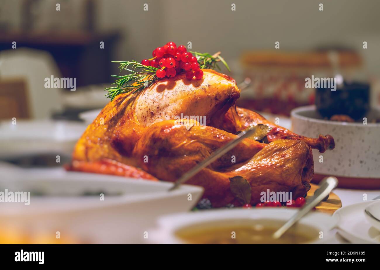 Tasty Fried Turkey in the Center of the Table for Thanksgiving Day. Festive Dinner at Home. Traditional American Holiday. Stock Photo