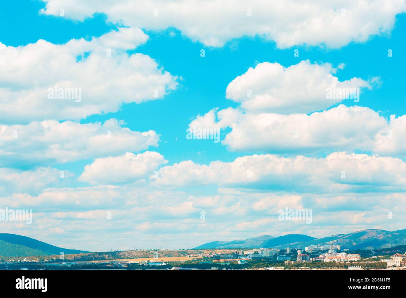 Landscape. Blue bright sky with white cumulus clouds over a mountain ...