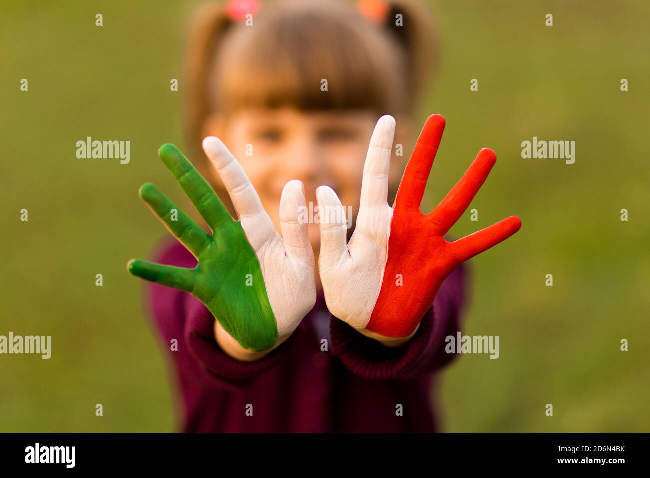 Painted kid hands in italy flag colors. Creative Stock Photo