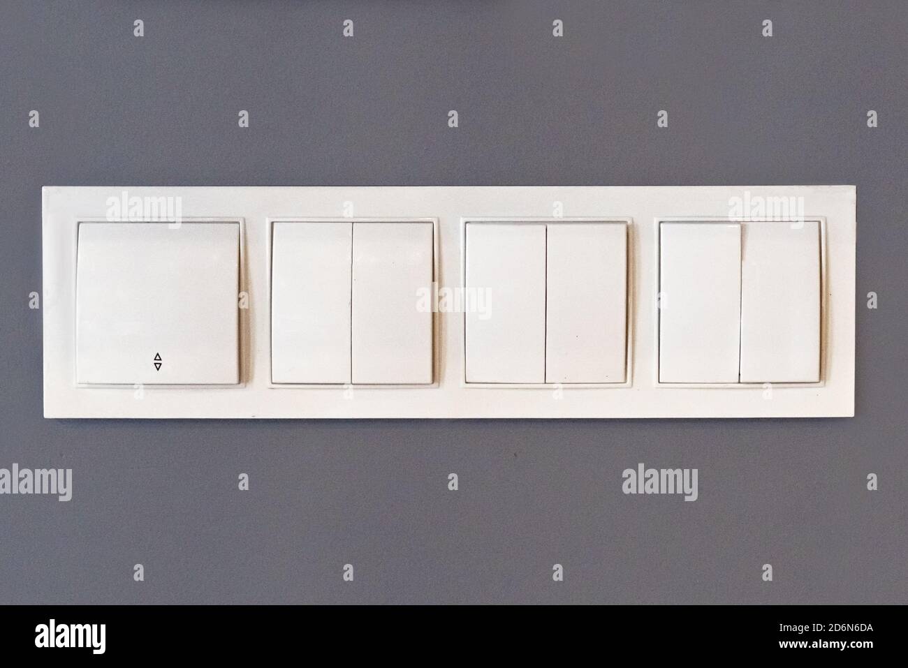 white plastic light switch on gray wall Stock Photo