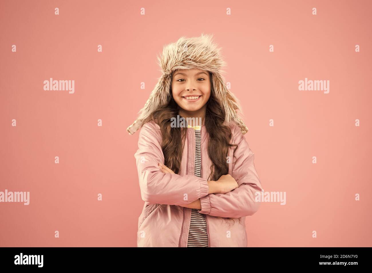 Playful kid girl wear fur hat 