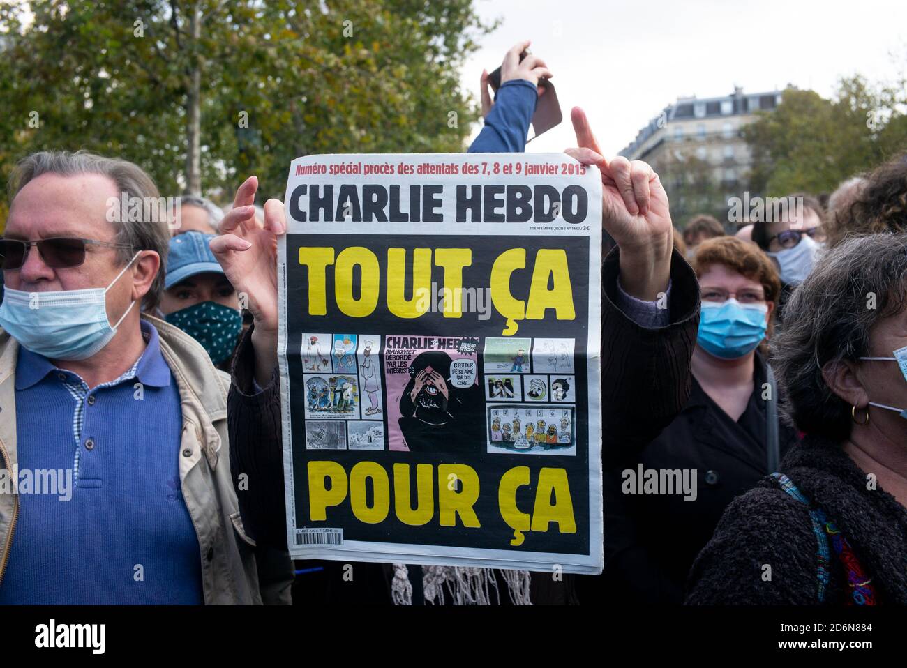 An issue of the satirical magazine, Charlie Hebdo with the headline 'All This For This' carried by a protester during the tribute.Thousands gathered at the Place de la Republique to protest and pay tribute to 47-year-old history teacher Samuel Paty, beheaded on October 16th after showing caricatures of the Prophet Muhammad in class. Stock Photo