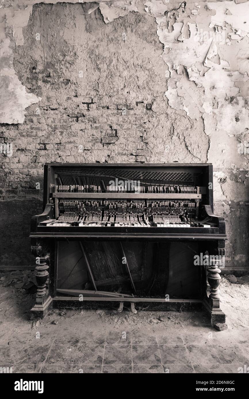 Rotten piano, located in an abandoned farm Stock Photo
