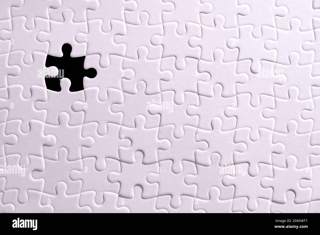 White puzzle and one missing puzzle piece Stock Photo