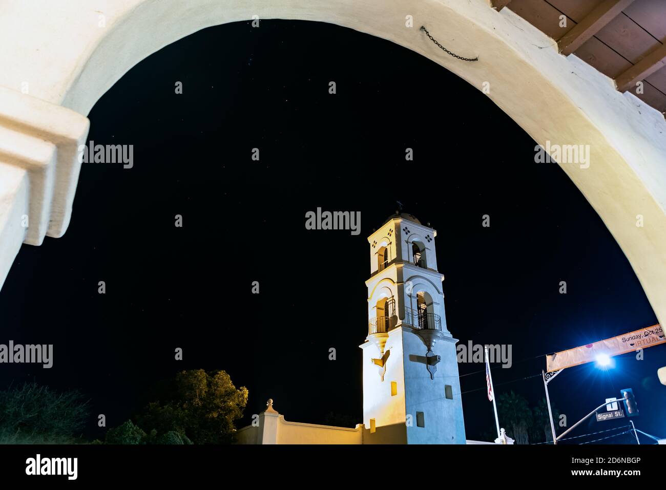 Architectural arch frames the Ojai tower against the night sky twinkling with constellation stars. Stock Photo