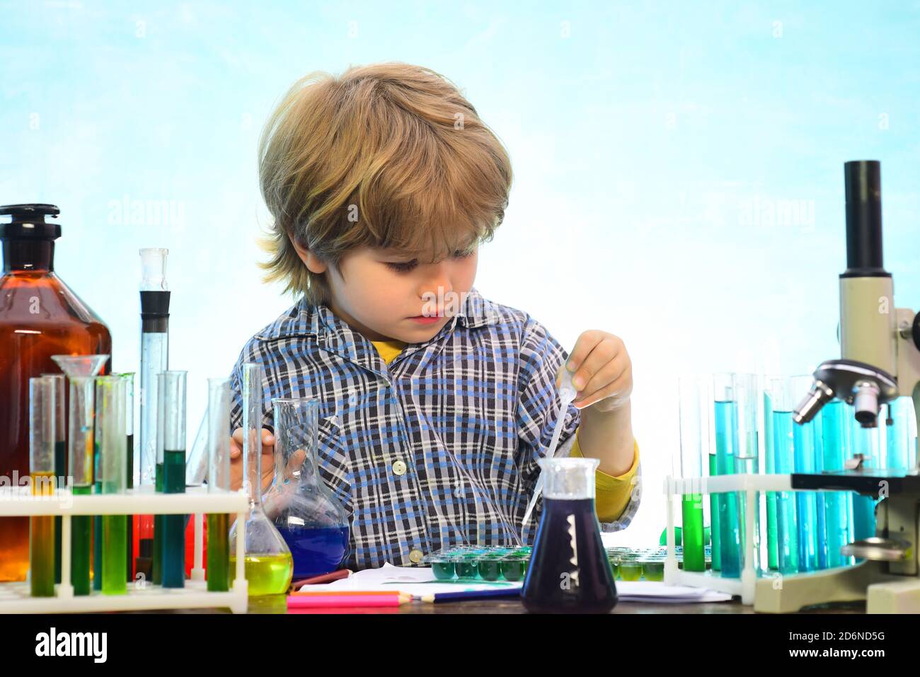 Little kids scientist earning chemistry in school lab. What is taught in chemistry. Lab microscope and testing tubes. School concept. Back to school Stock Photo