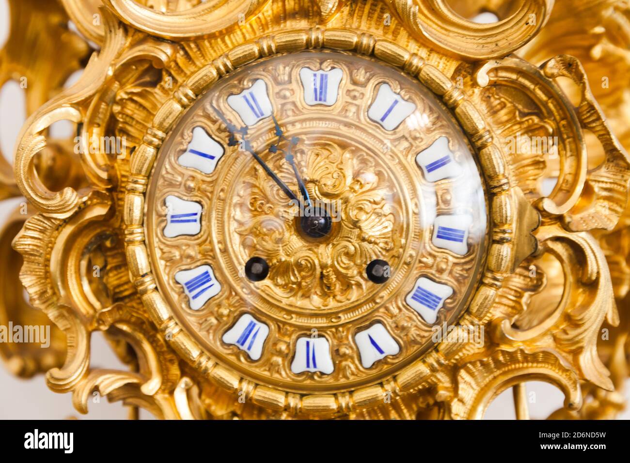 Vintage grandfather clock dial with golden decoration and roman numerals. Close up photo Stock Photo