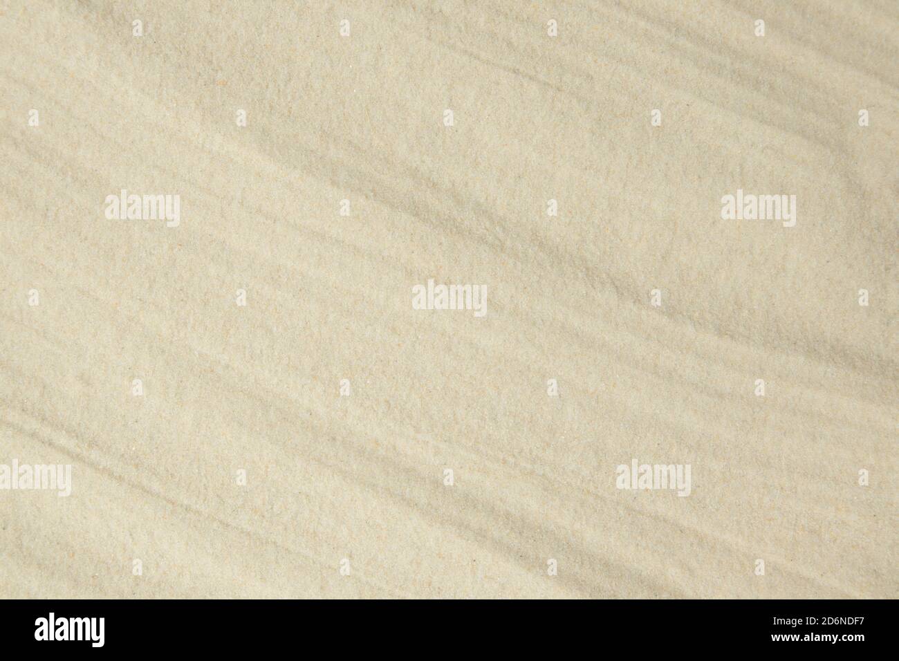 A background of fine quartz sand, laid with soft waves. Template. Stock Photo