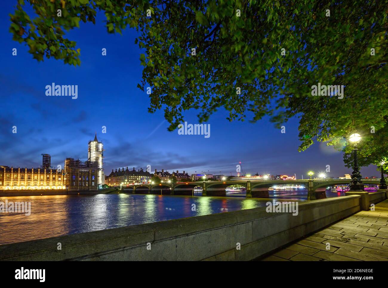 Houses of Parliament in Westminster, London, UK. View across the Thames with Westminster Bridge. Vehicle light trails and long exposure motion blur. Stock Photo