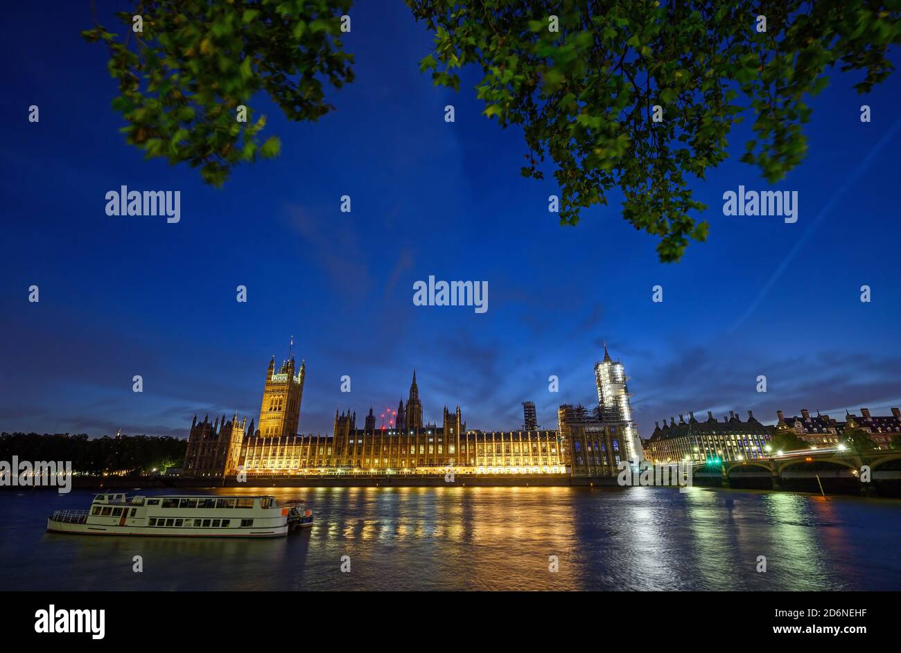 Houses of Parliament in Westminster, London, UK. View across the Thames with Westminster Bridge. Boat in foreground and long exposure motion blur. Stock Photo