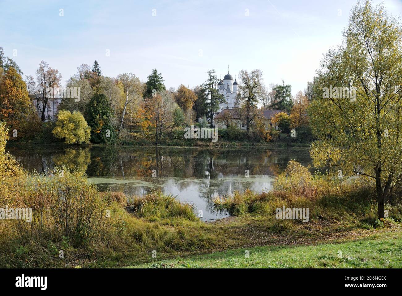 = Autumn reflections at Vayzemka River =  Beautiful Autumn scenery with the view from Golitsino park of Heroes of 1812 on the estate with old Church o Stock Photo