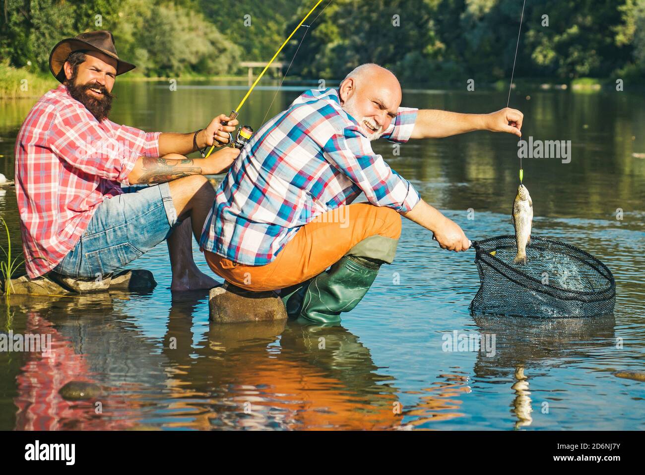 Father with son on the river fishing. Fly angler on the river. Still