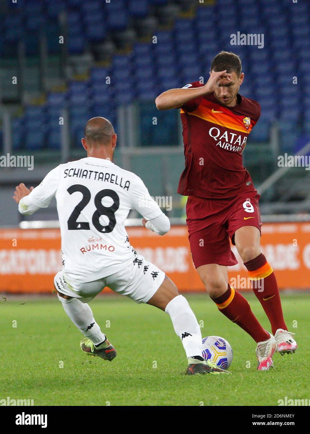Rome, Italy. 18th Oct, 2020. Roma s Edin Dzeko, right, is challenged by Benevento s Pasquale Schiattarella during the Serie A soccer match between Roma and Benevento at the Olympic Stadium. Credit: Riccardo De Luca - Update Images/Alamy Live News Stock Photo