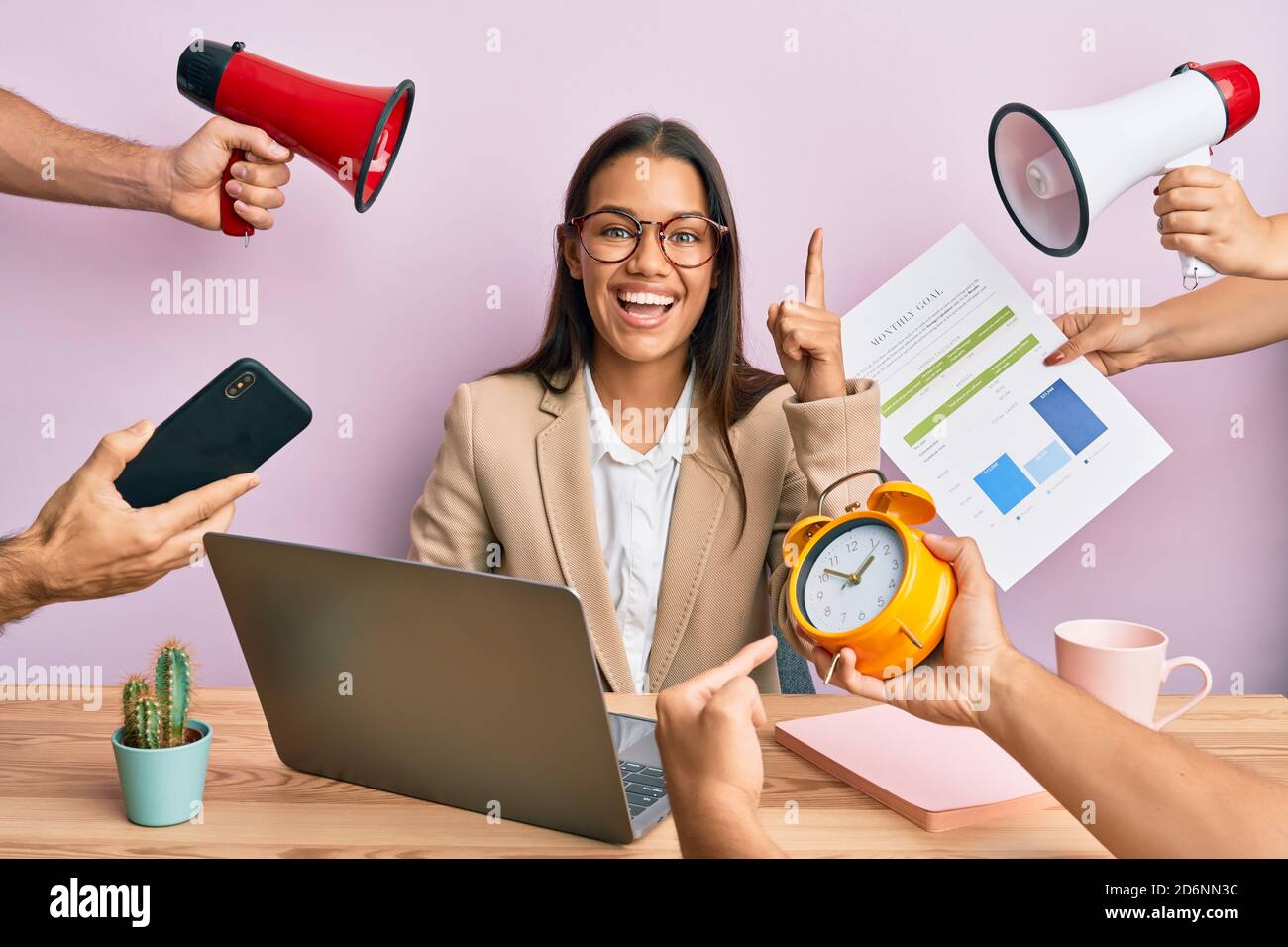 Beautiful hispanic woman working at the office under stress pointing ...