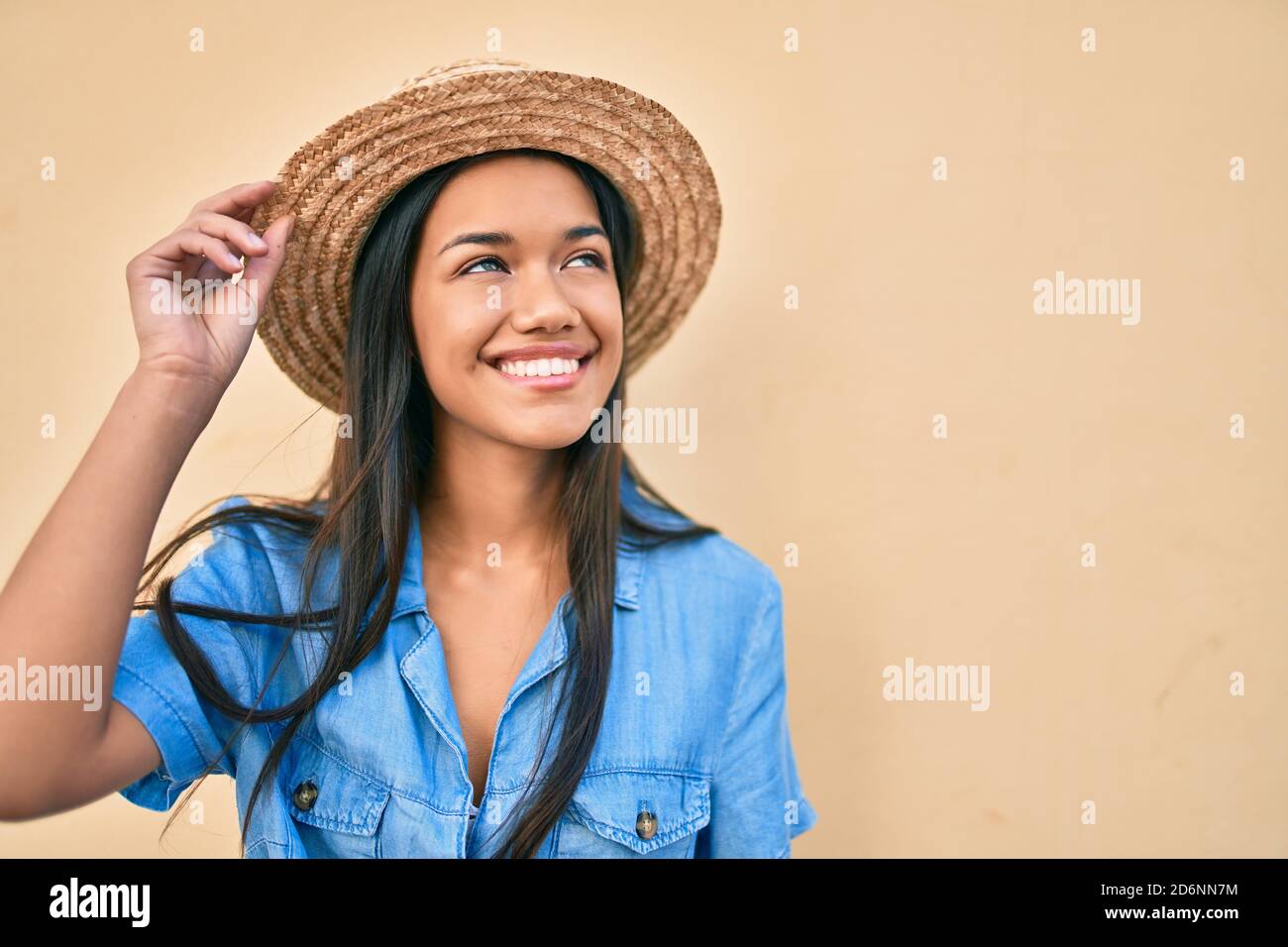 Young latin tourist girl on vacation smiling happy walking at the city ...