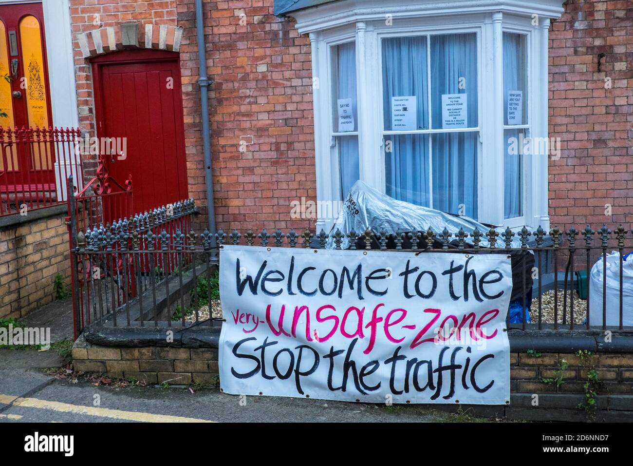 Homemade, sign,signage,highlighting,residents,feeling,unsafe,due,to,a,traffic,issue,of,road,car,cars,vehicle,usage,of,traffic,going,through,town,centre,in, Photo, taken on, Quay Street,in,centre,of,Cardigan,Cardigan Bay,Ceredigion,Ceredigion county,Wales,West Wales,Welsh,U.K.,Europe,European,car accidents, safe,safety,road usage, breathing,difficulties,pollution,car pollution, motor vehicle pollution, air quality, Britain,British Stock Photo