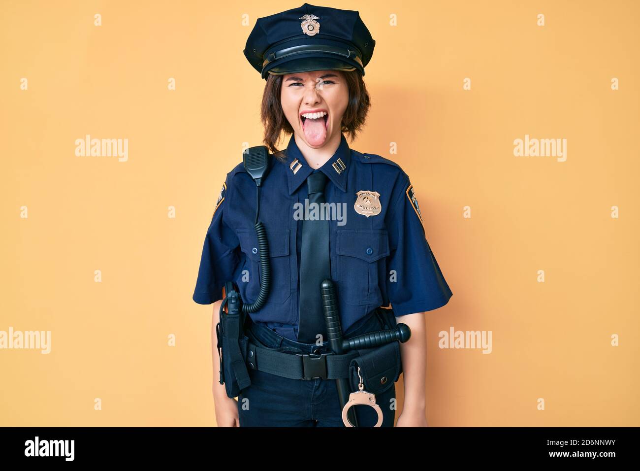 Young beautiful woman wearing police uniform sticking tongue out happy with funny expression. emotion concept Stock Photo - Alamy Young beautiful woman wearing police uniform sticking tongue out happy with funny expression. emotion concept Stock Photo - Alamy