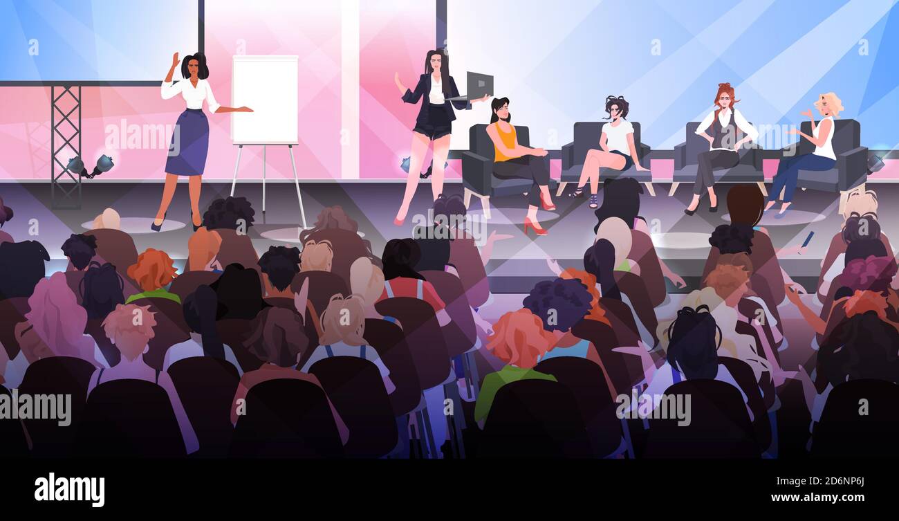 women making presentation speaking to audience from stage women's club