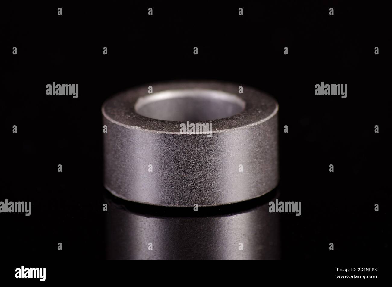 Ferrite core ring in the shape of toroid isolated on the black