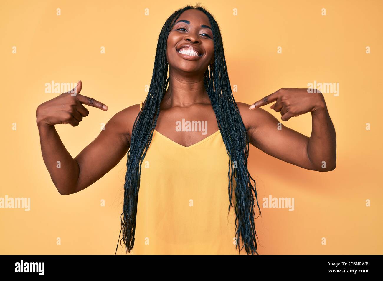 African american woman with braids wearing casual clothes looking ...