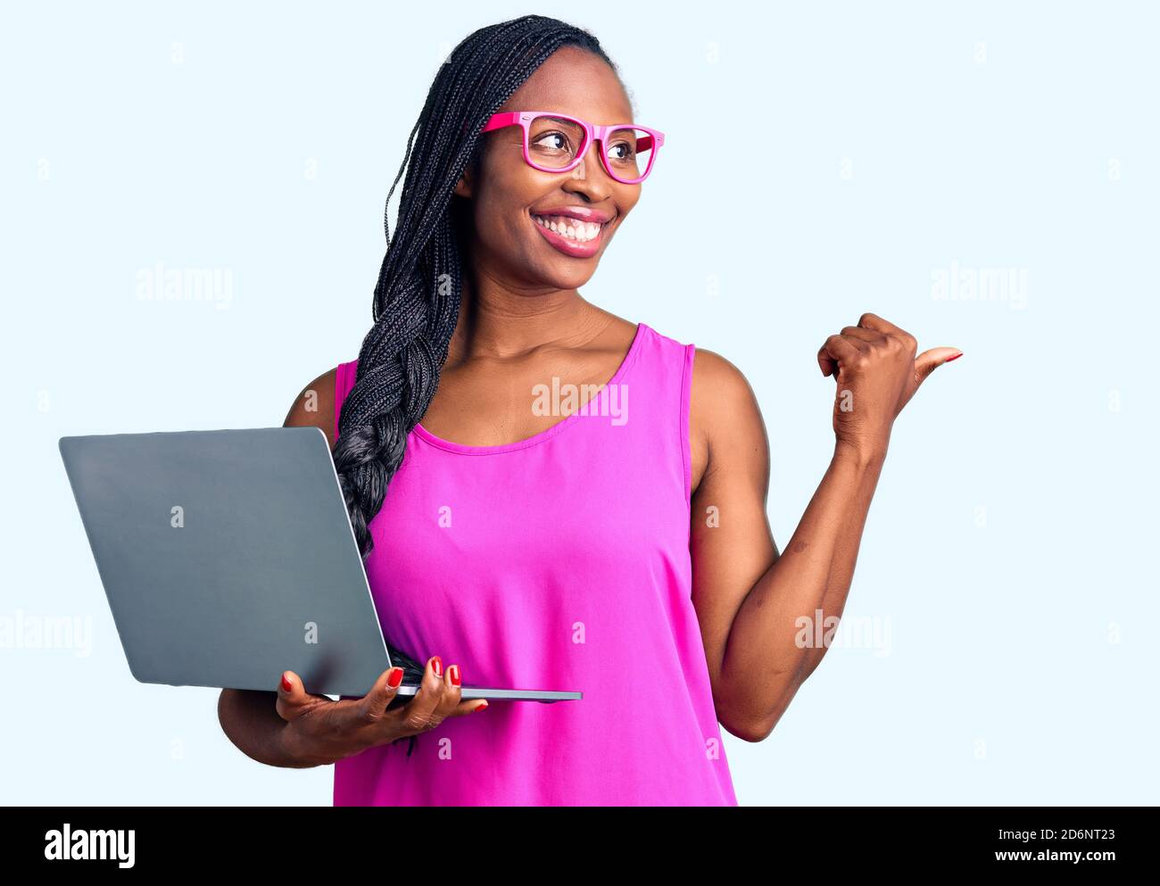 Young african american woman working using computer laptop pointing ...