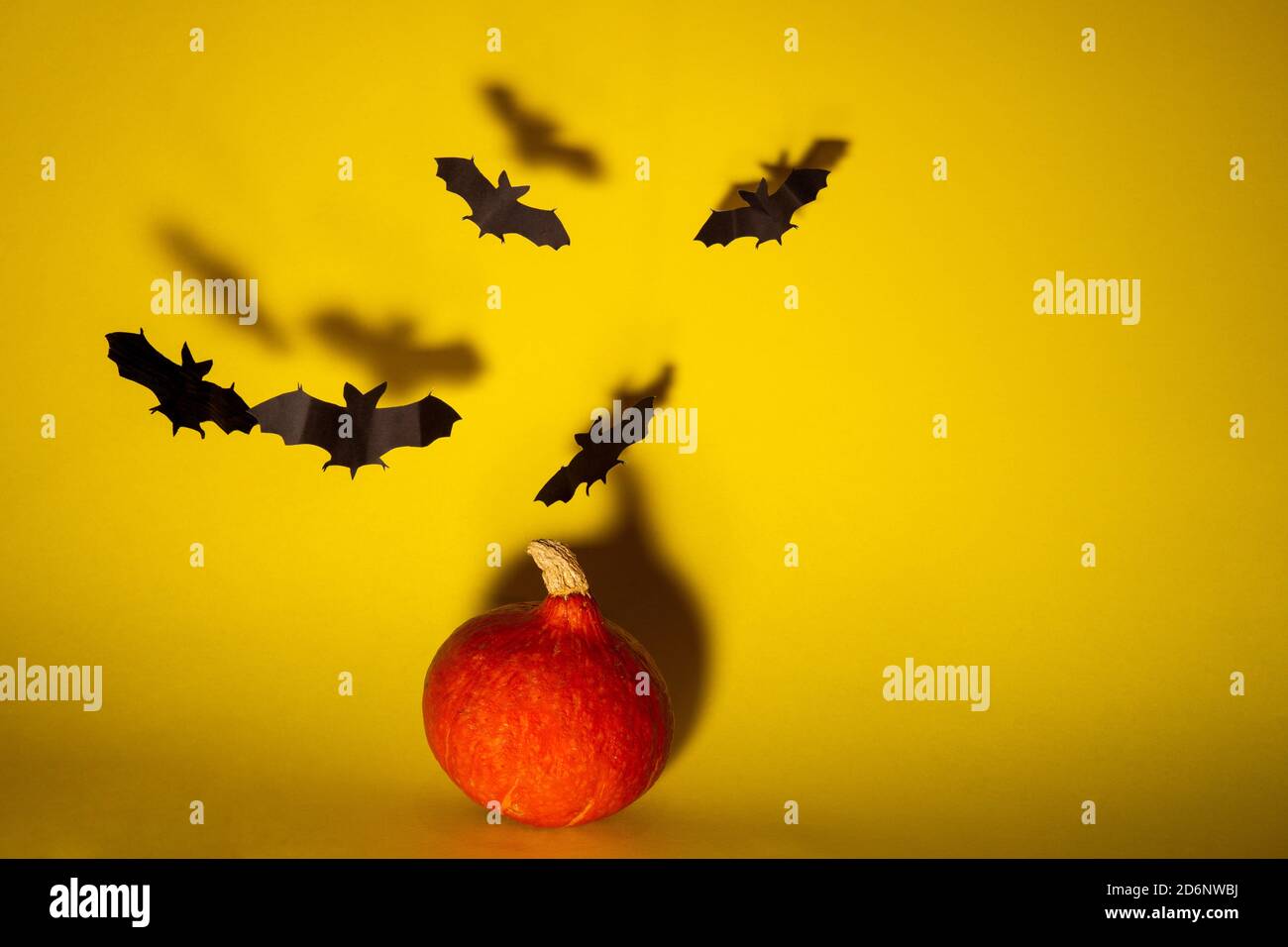 Halloween pumpkin with flying bats made of paper Stock Photo