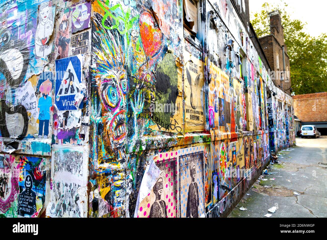 Walls covered in graffiti, posters and artwork by Brick Lane, East