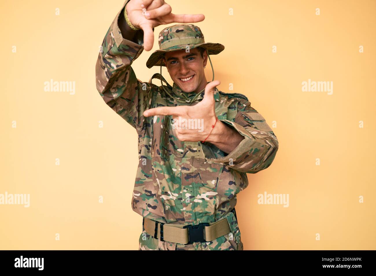 Young Handsome Man Wearing Camouflage Army Uniform Smiling Making Frame  With Hands And Fingers With Happy Face. Creativity And Photography Concept  Stock Photo - Alamy