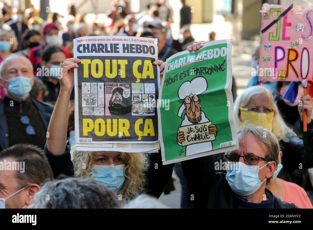 Protesters wearing face masks hold placards during the demonstration ...