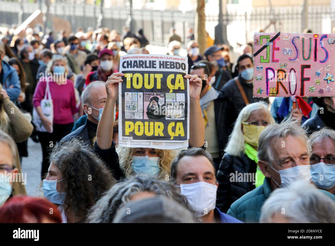 Protesters wearing face masks hold placards during the demonstration ...