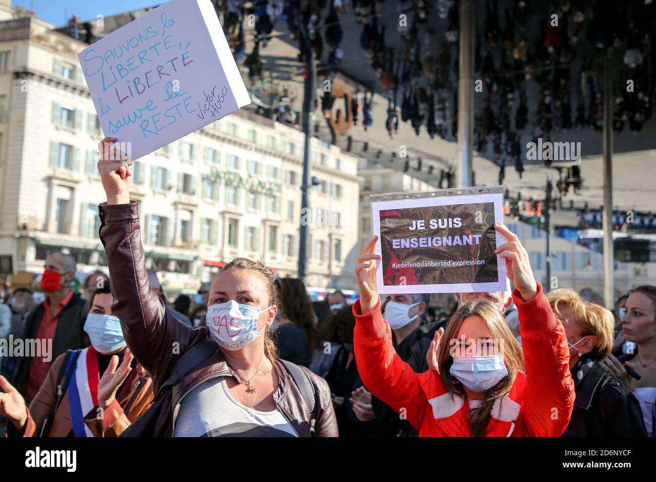 Protesters wearing face masks hold placards during the demonstration ...