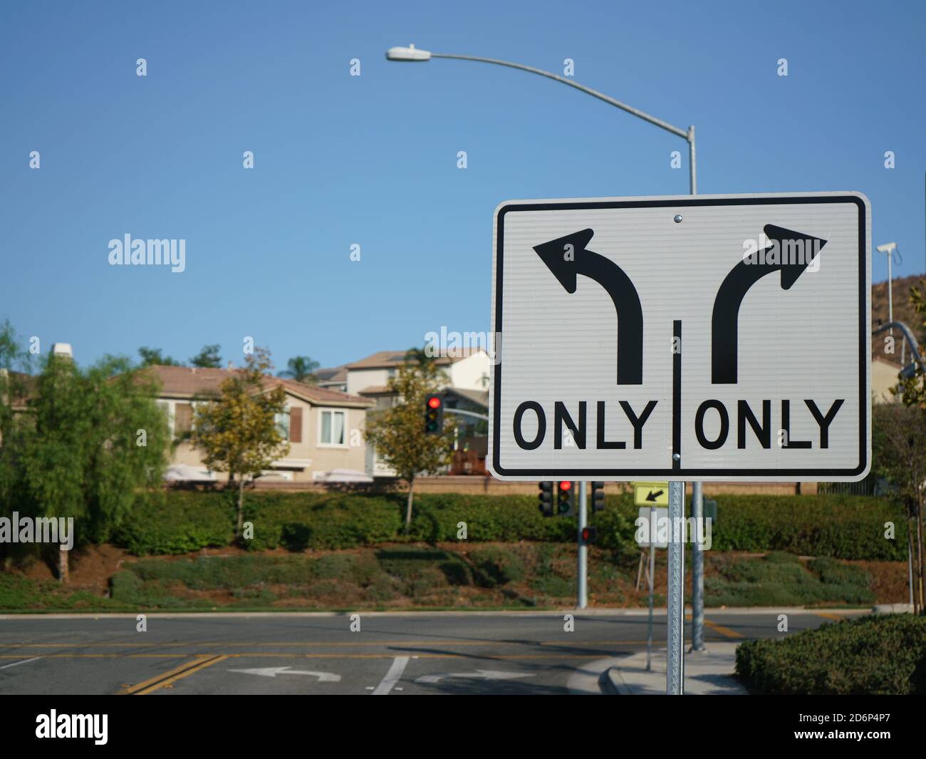 Turn Only Road Sign with intersection in background Stock Photo