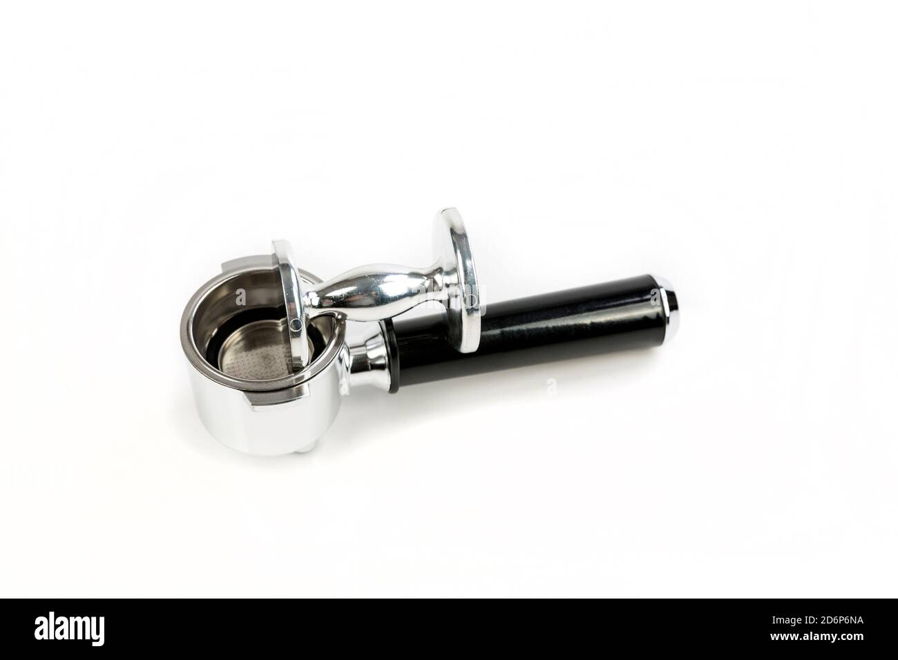 Black and silver coffee filter holder with a metal coffee tamper laying on top side view Stock Photo