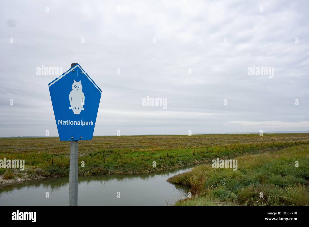 Wadden National Park Sign with salt marsh behind. Wadden Sea. Lower Saxony. Germany Stock Photo