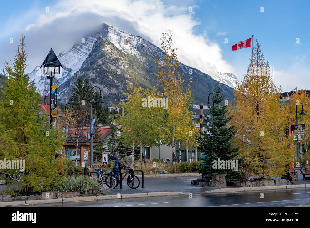 Street view of Banff Avenue in autumn and winter snowy season. Snow Capped Mount Rundle in the background. Banff, Alberta, Canada Stock Photo
