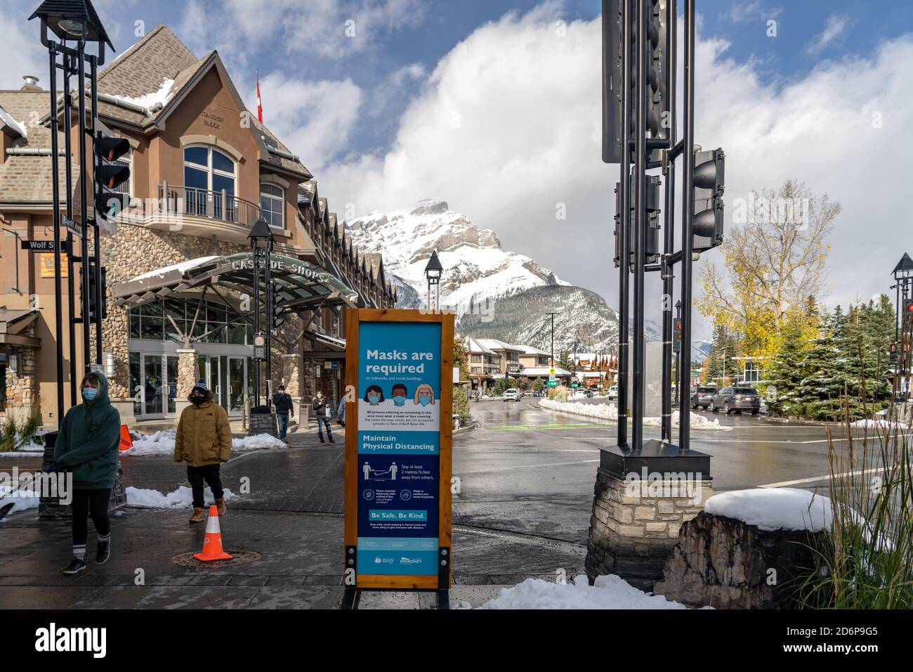 Street view of Banff Avenue in autumn and winter snowy season sunny day during covid-19 pandemic period. Banff, Alberta, Canada Stock Photo