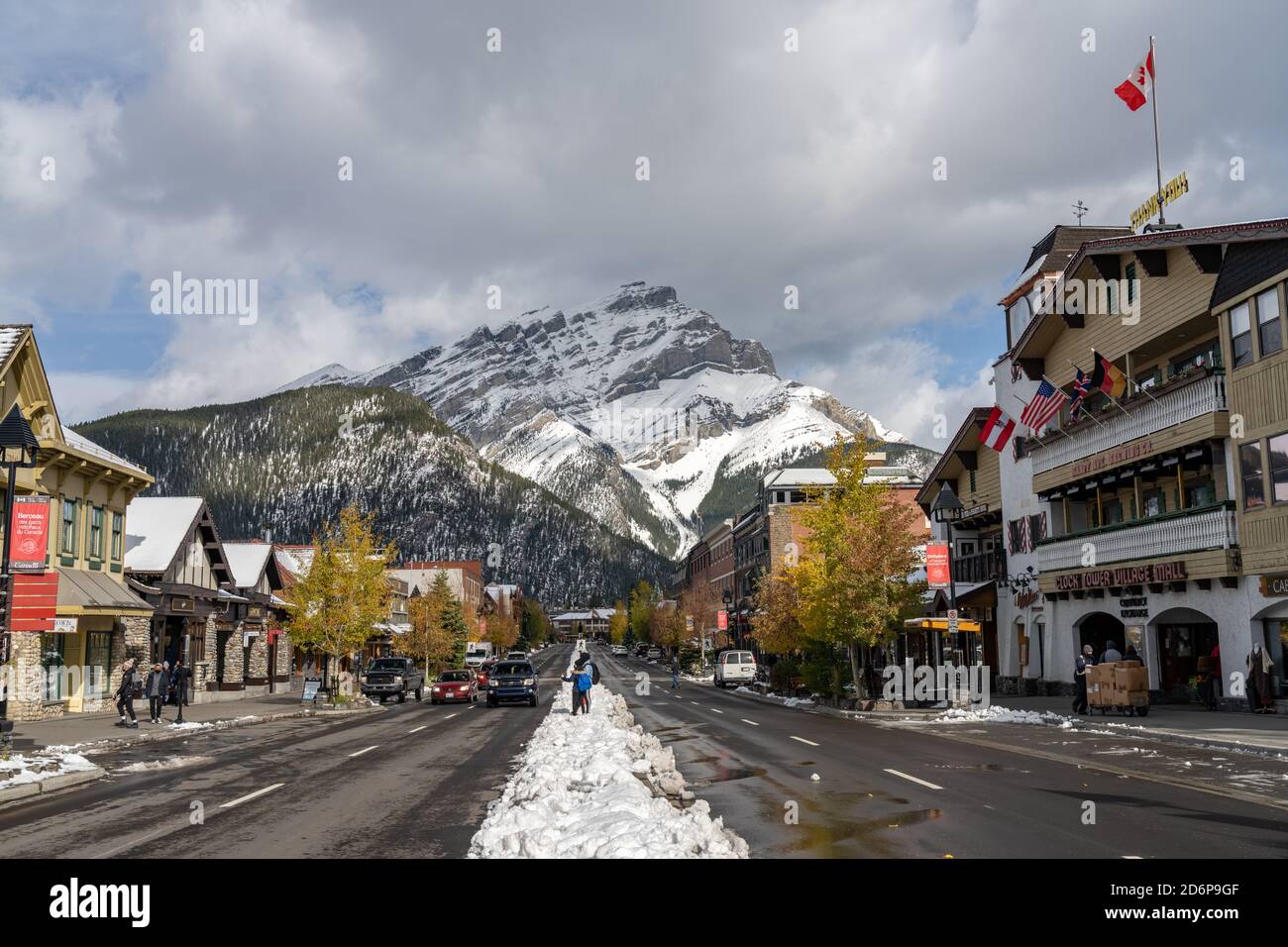 Street view of Banff Avenue in autumn and winter snowy season sunny day during covid-19 pandemic period. Banff, Alberta, Canada Stock Photo
