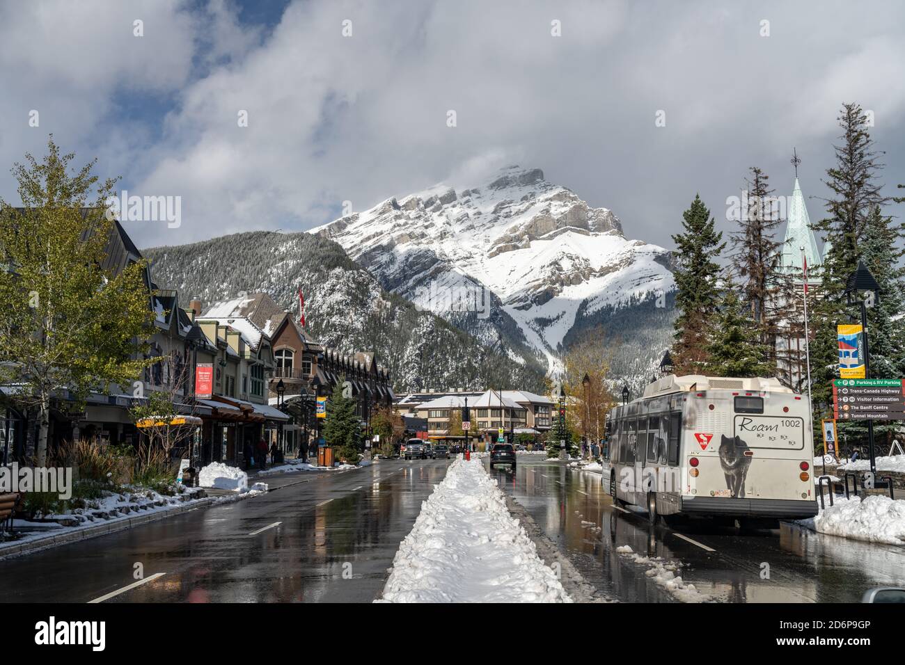 Street view of Town of Banff. Bus stop in Banff Avenue in autumn and winter snowy season. Banff, Alberta, Canada Stock Photo