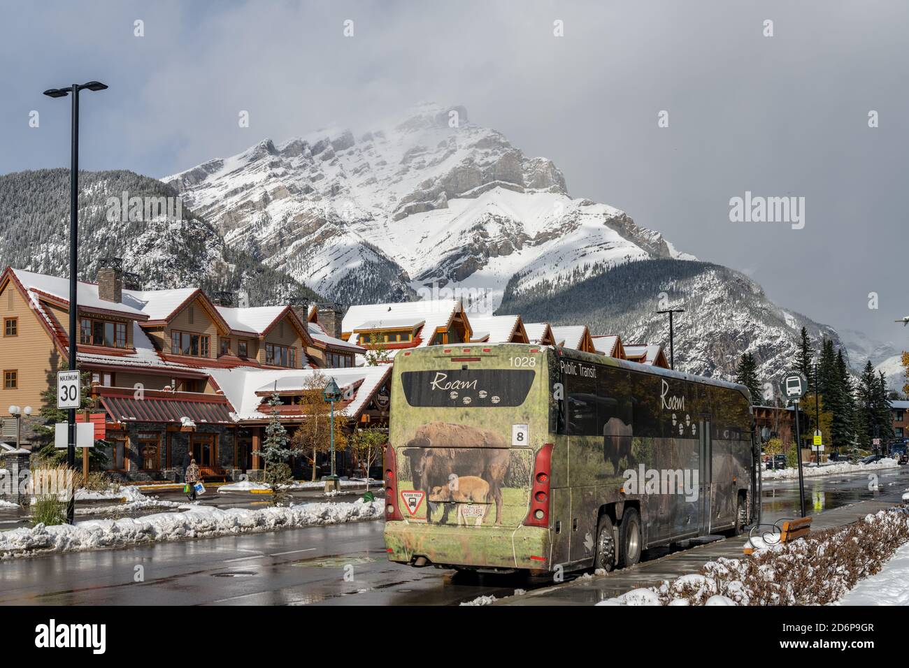 Street view of Town of Banff. Bus stop in Banff Avenue in autumn and winter snowy season. Banff, Alberta, Canada Stock Photo
