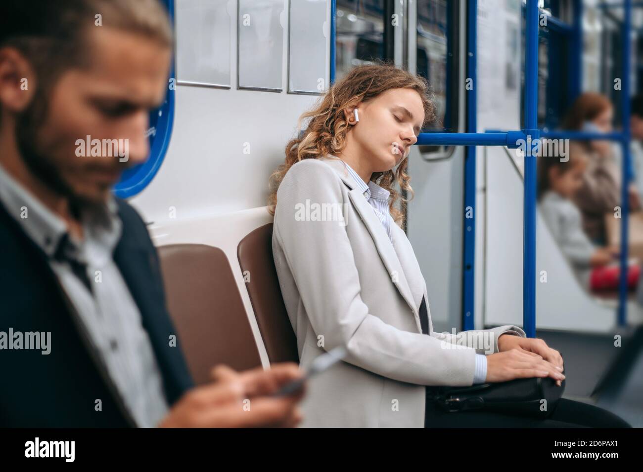 tired young woman sleeps on a subway train Stock Photo - Alamy