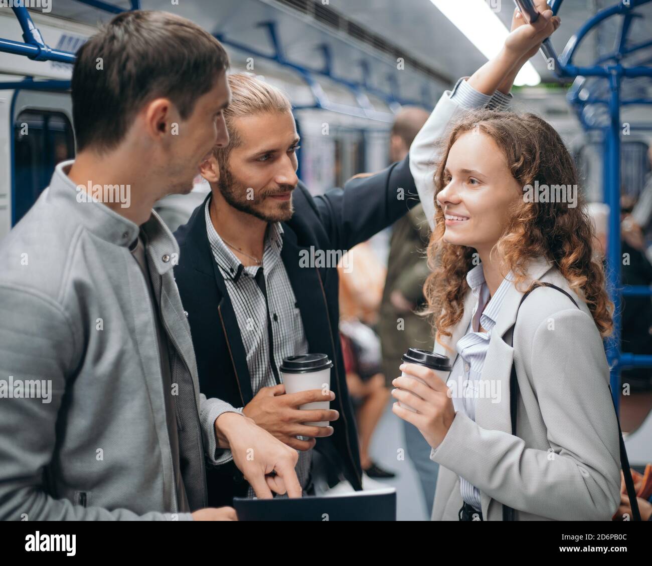 group of students discussing something in the subway car. Stock Photo